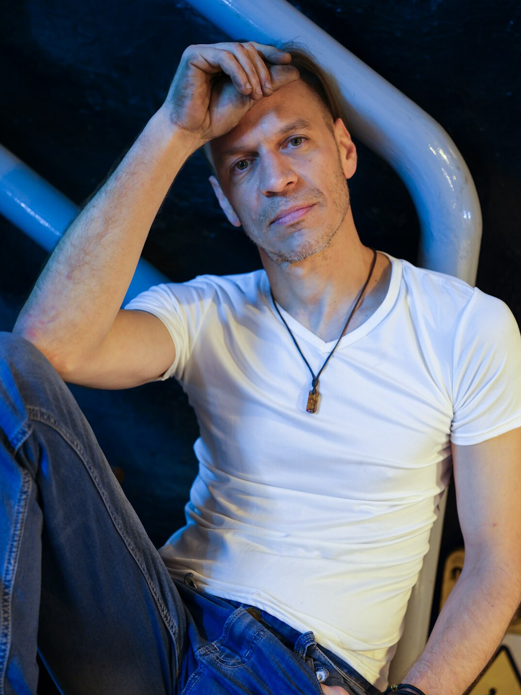 Professional portrait of a man in his thirties in a white shirt