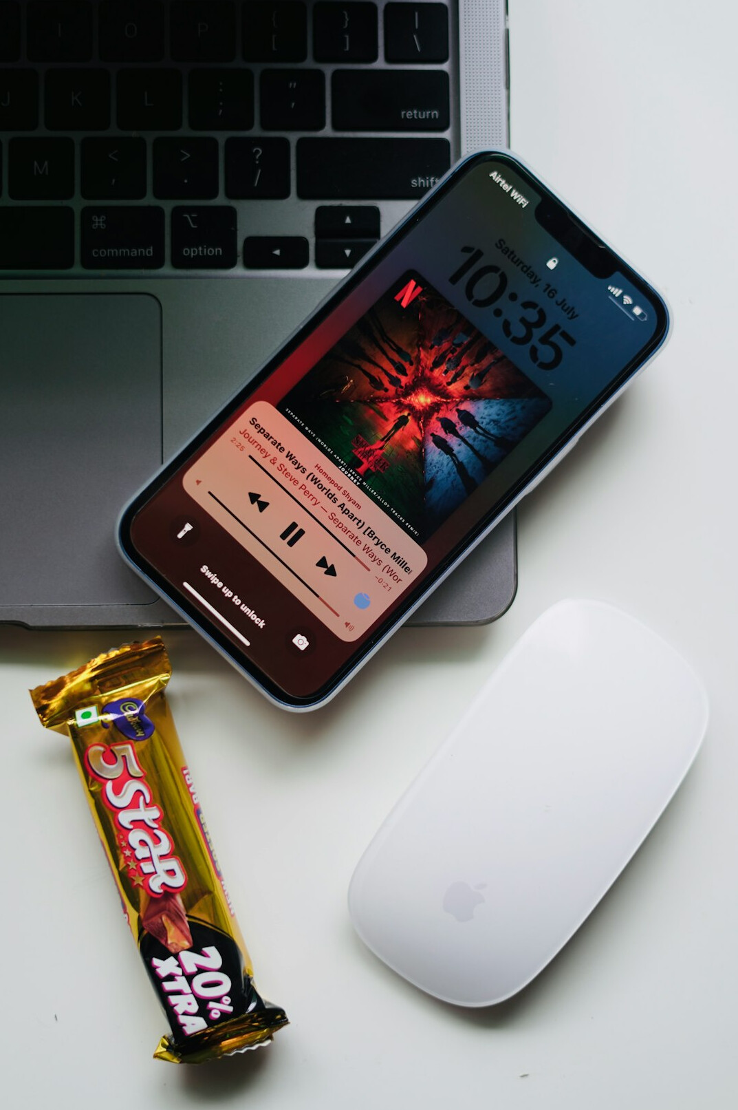 Laptop and smartphone on a desk with a warning notification