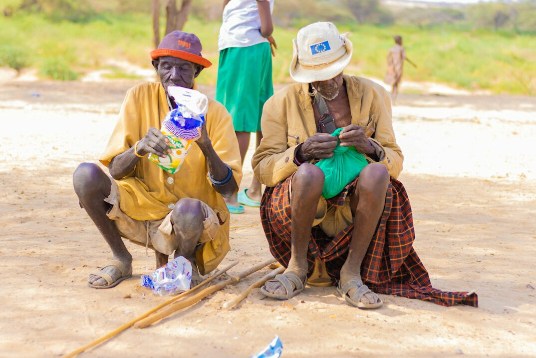 Senior couple learning to use a smartphone with a helper