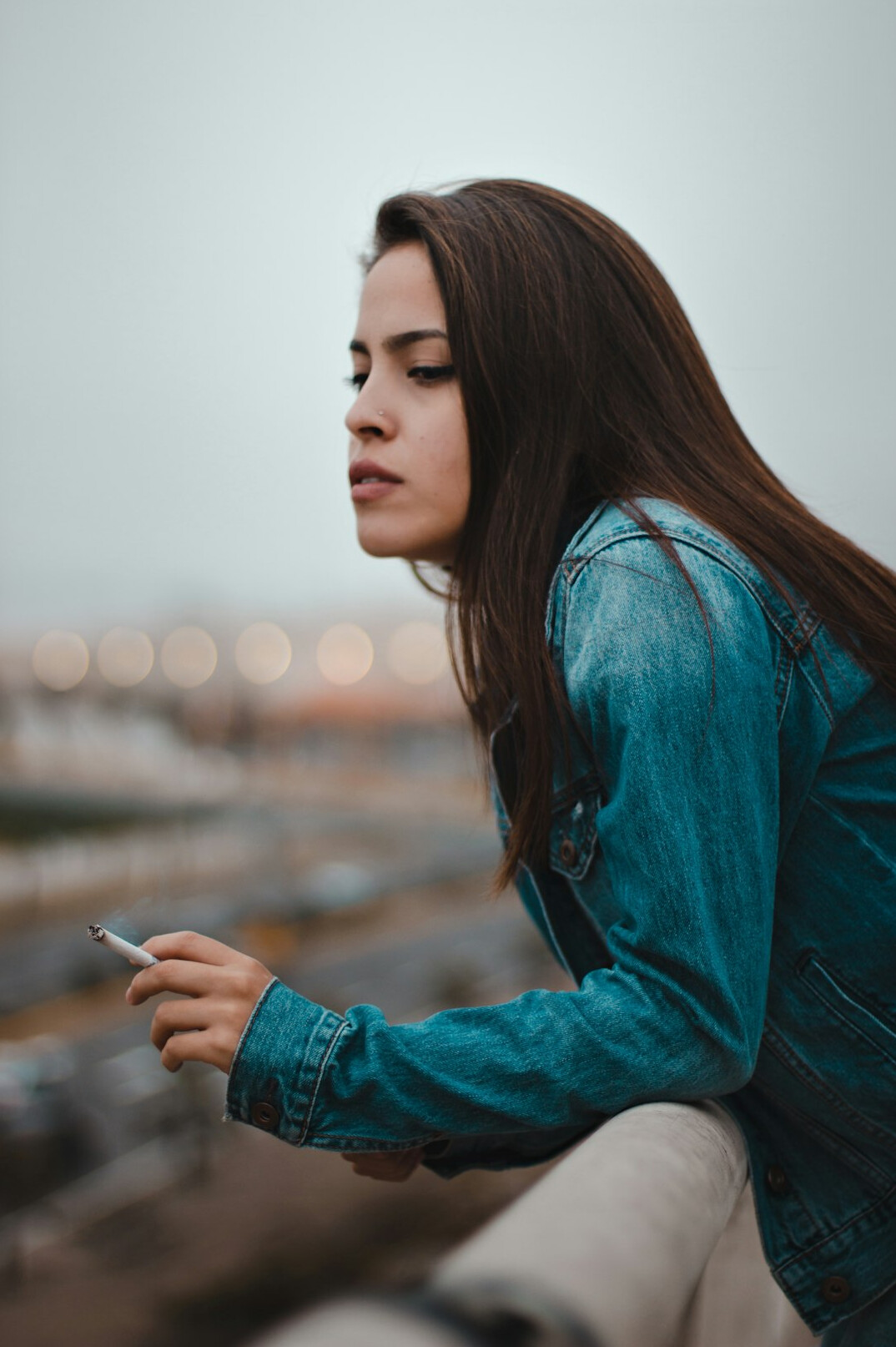 Woman reading a message on her phone with a thoughtful look